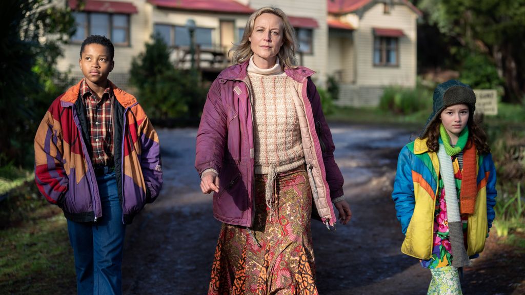 woman and children walking away from house