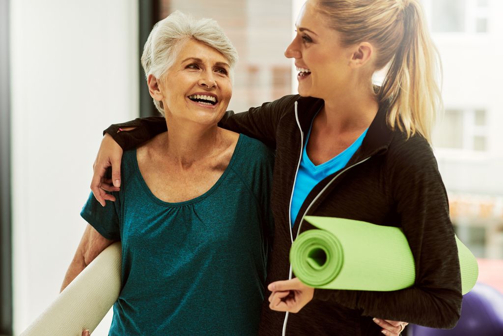 older woman and younger woman leaving yoga class