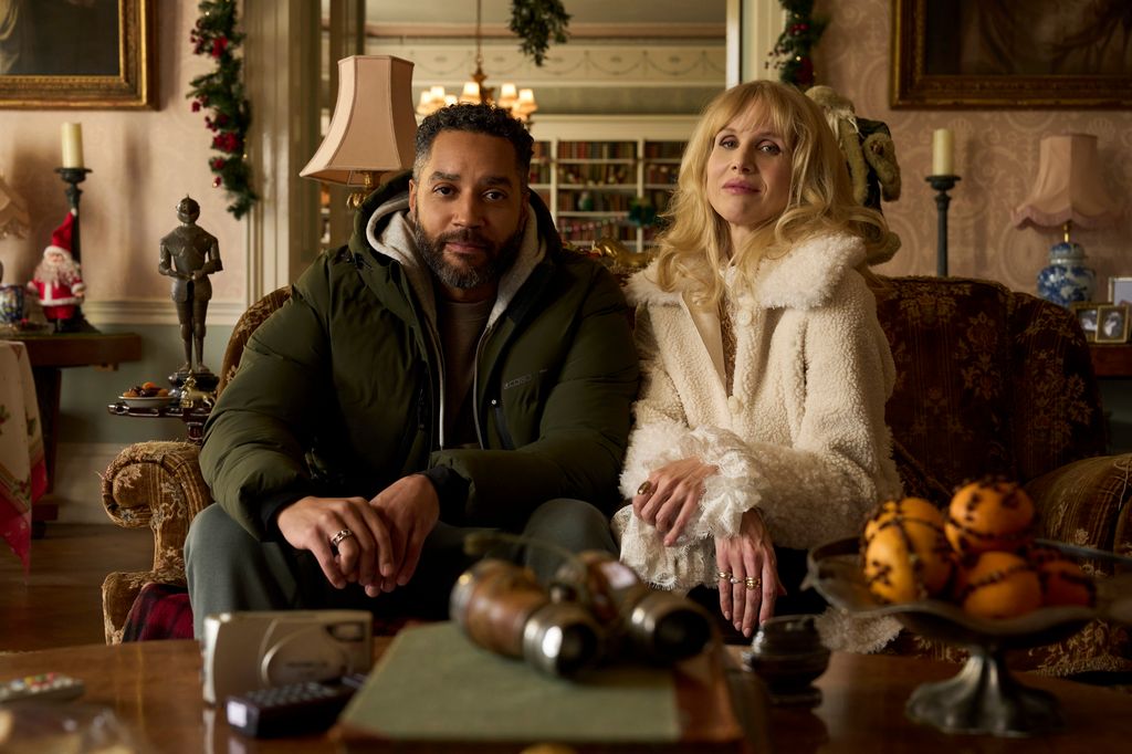 man and woman sitting on sofa