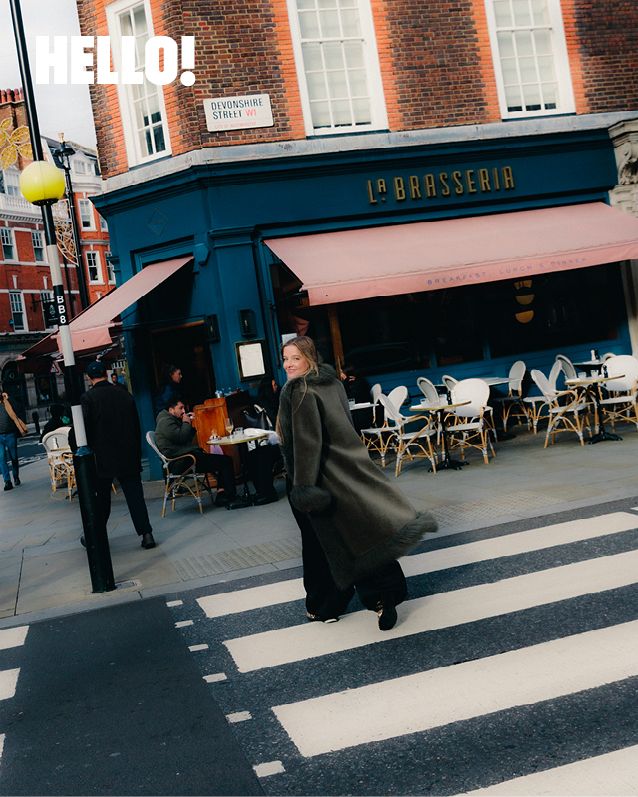 woman crossing the road in a fluffy coat 