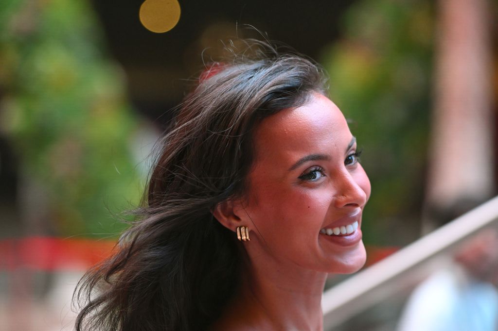 Maya Jama smiling photographed from the side 