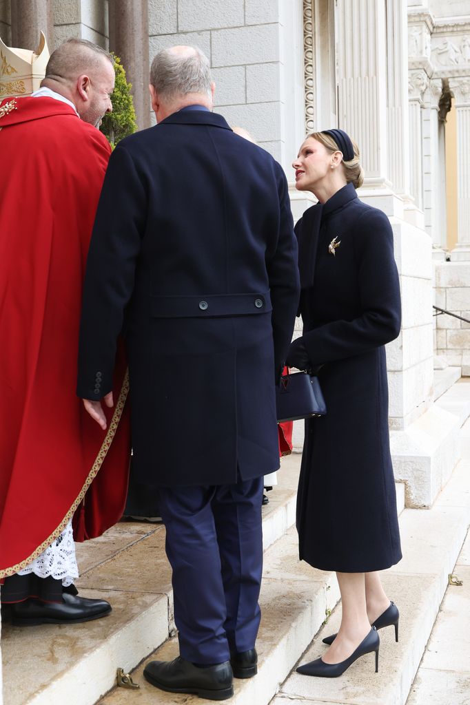 Princess Charlene talking to priest beside albert