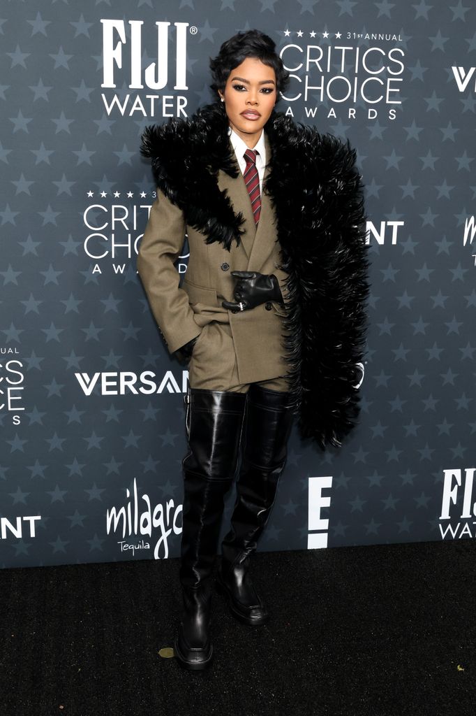 Teyana Taylor posed in suit and fur shawl