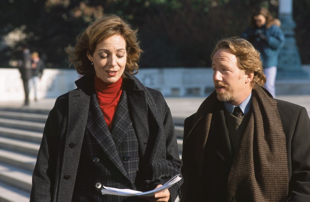 Allison Janney as Claudia Jean 'C.J.' Cregg, Timothy Busfield as Danny Concannon