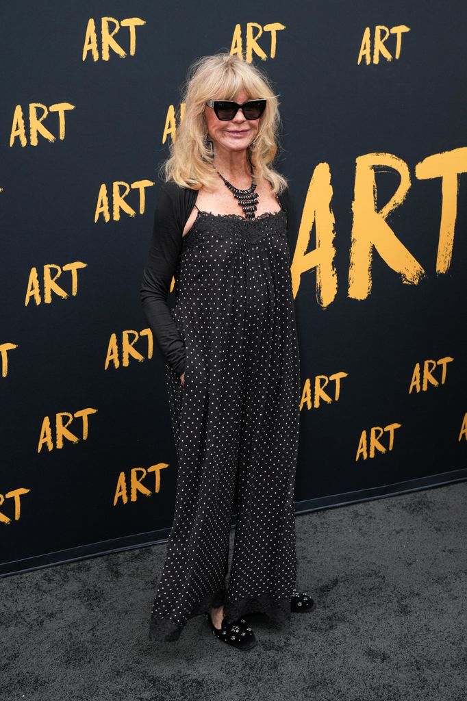 Goldie Hawn wearing a lacy polka dot dress and sunglasses