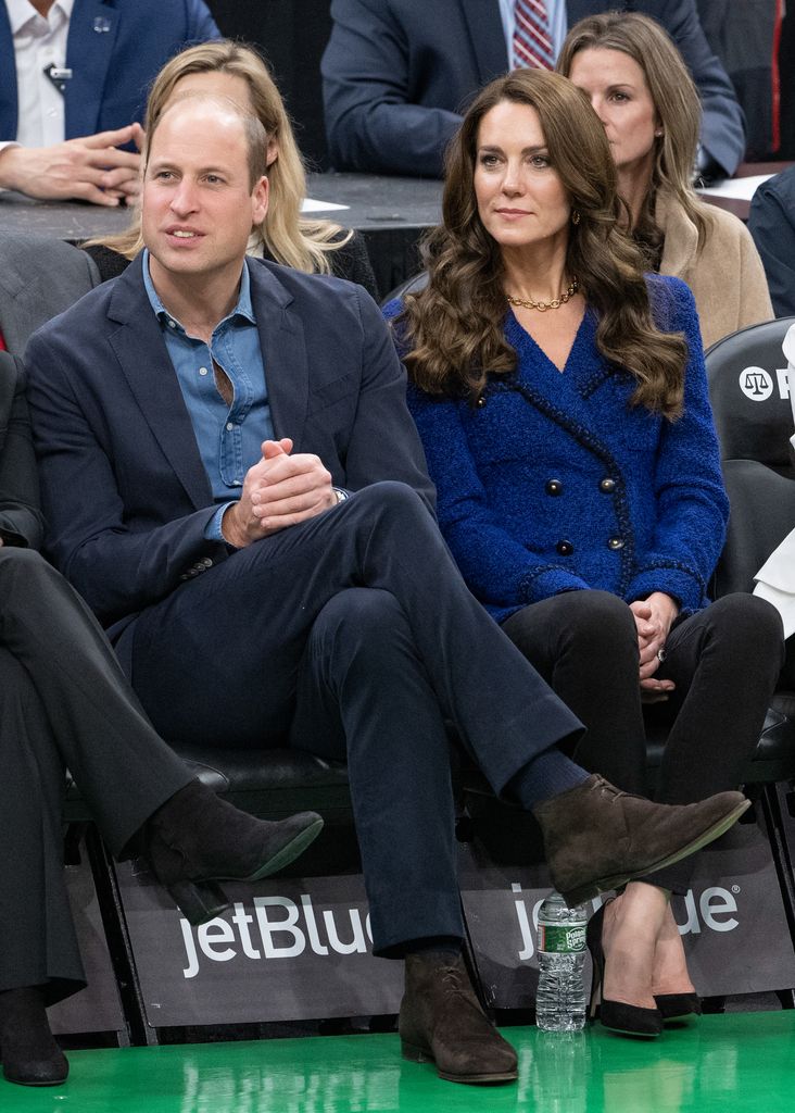 Kate sitting in basketball stands with william 