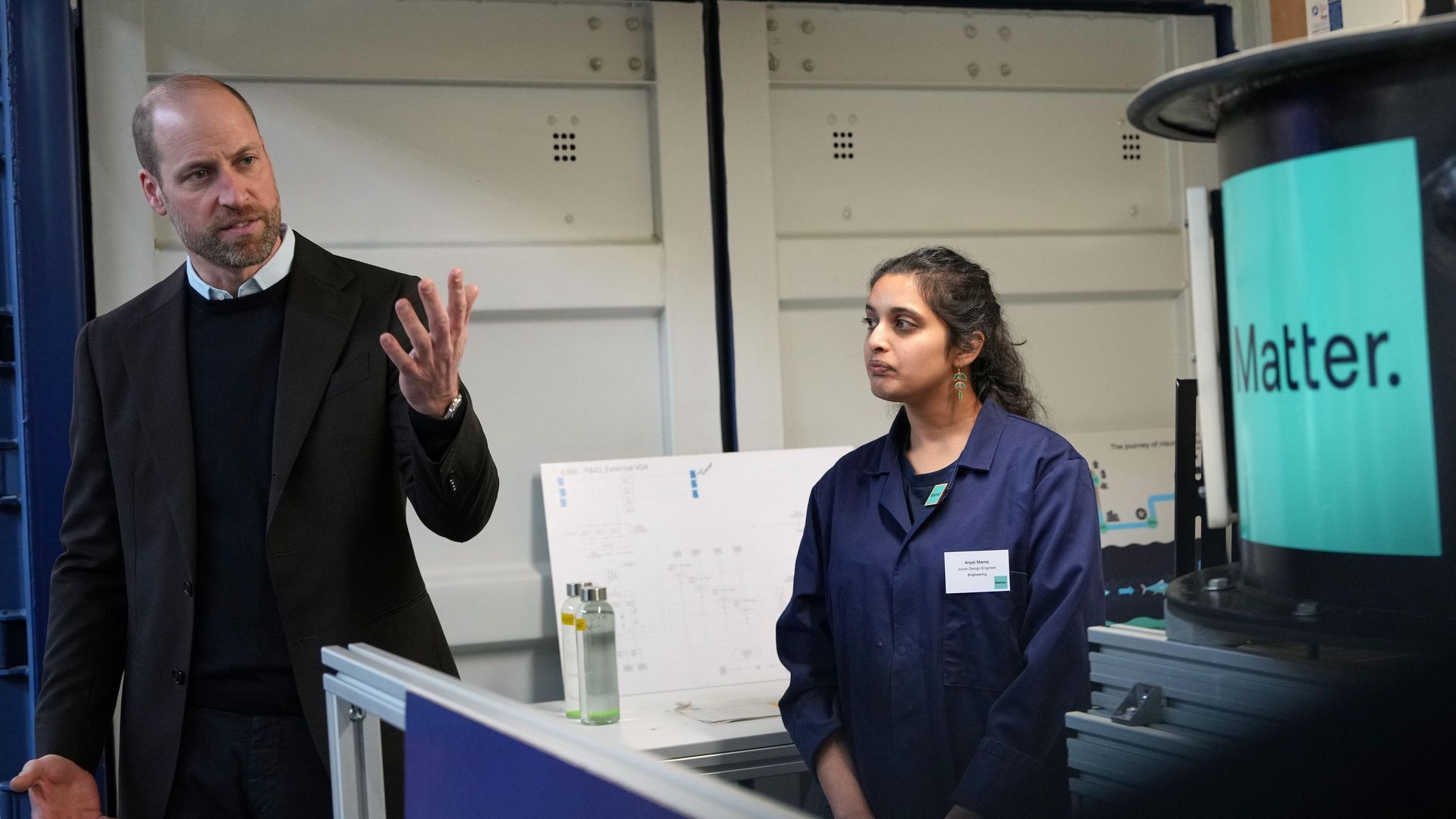 Prince William gesturing near a woman