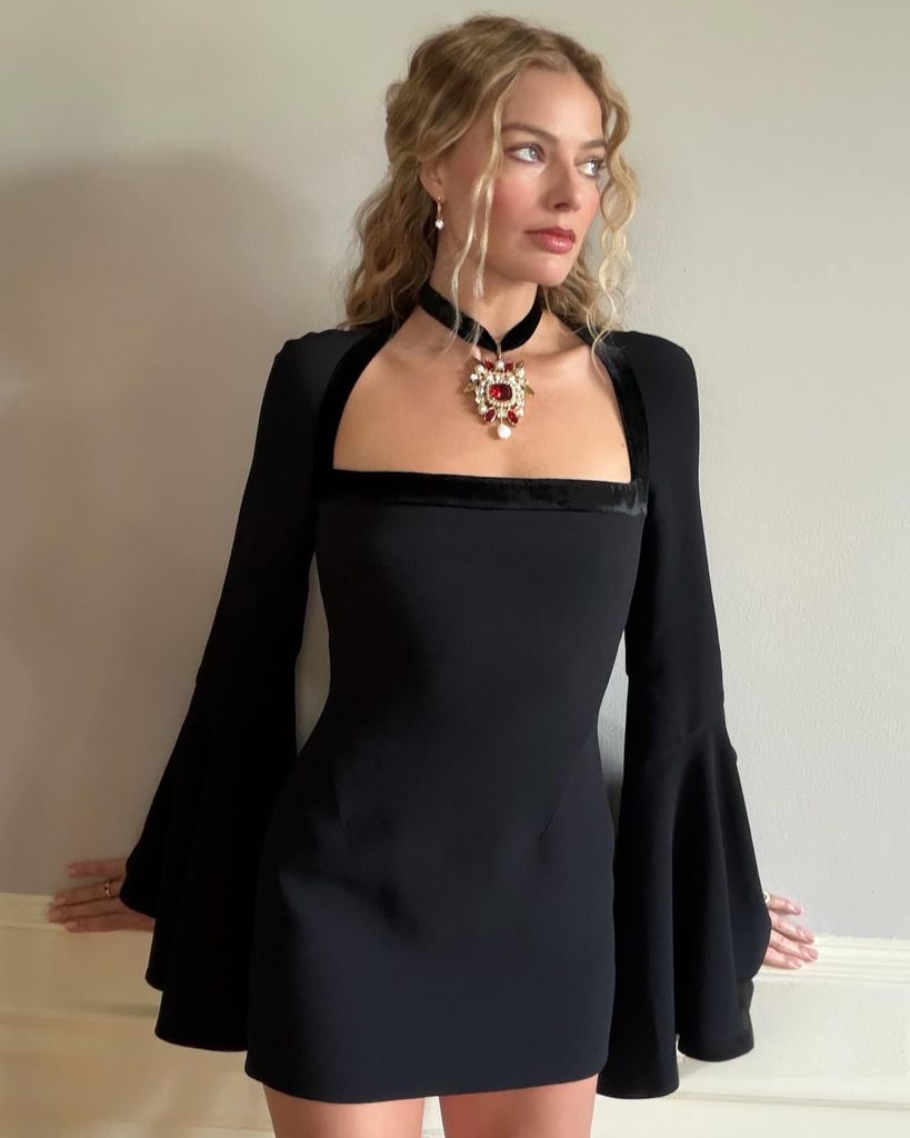 Margot Robbie poses in a black mini dress on her stylists Instagram