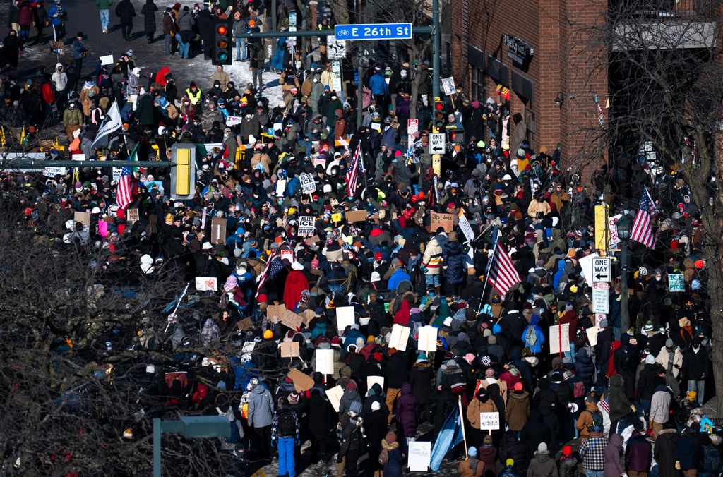 People gather at the intersection of 26th Street and Nicollet Avenue after a fatal shooting by federal agents on January 24, 2026 in Minneapolis, Minnesota