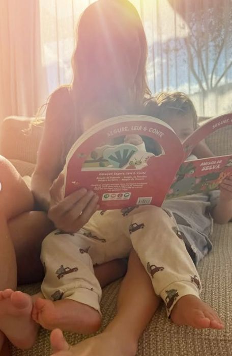 Gisele Bundchen reading a book with a child