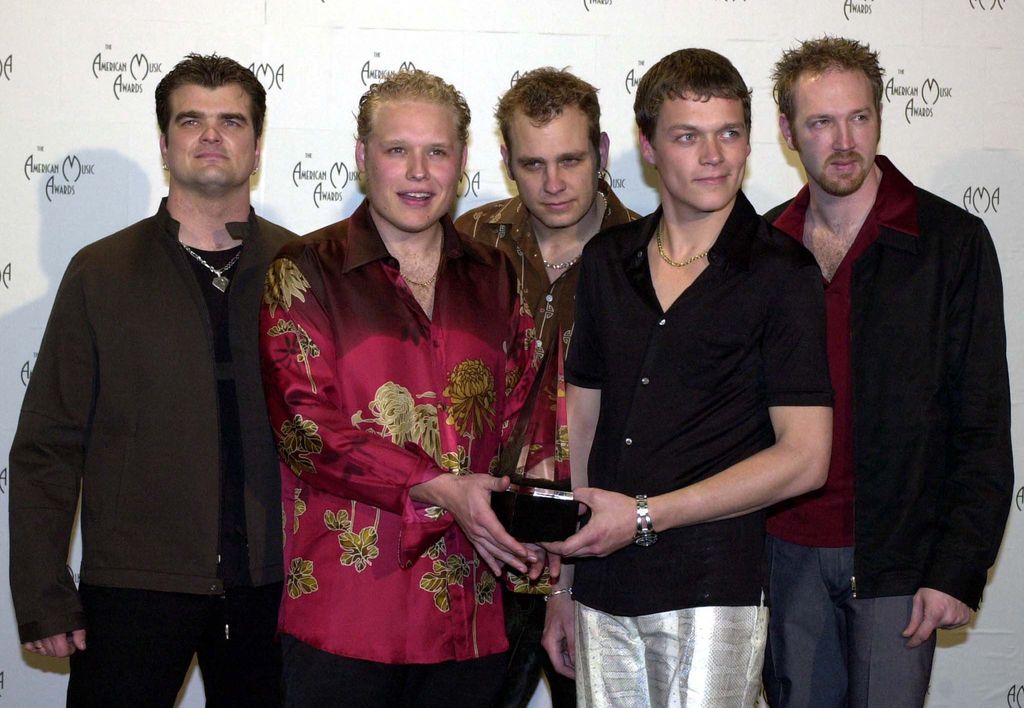 Chris Henderson, Todd Harrell, Matt Roberts, Brad Arnold, Rich Liles of the group 3 Doors Down, pose with their award for Favorite New Pop/Rock Artist at the 28th Annual American Music Awards in 2001
