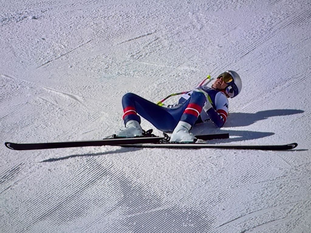 Lindsey Vonn lying on the crowd with her skis after she crashes 