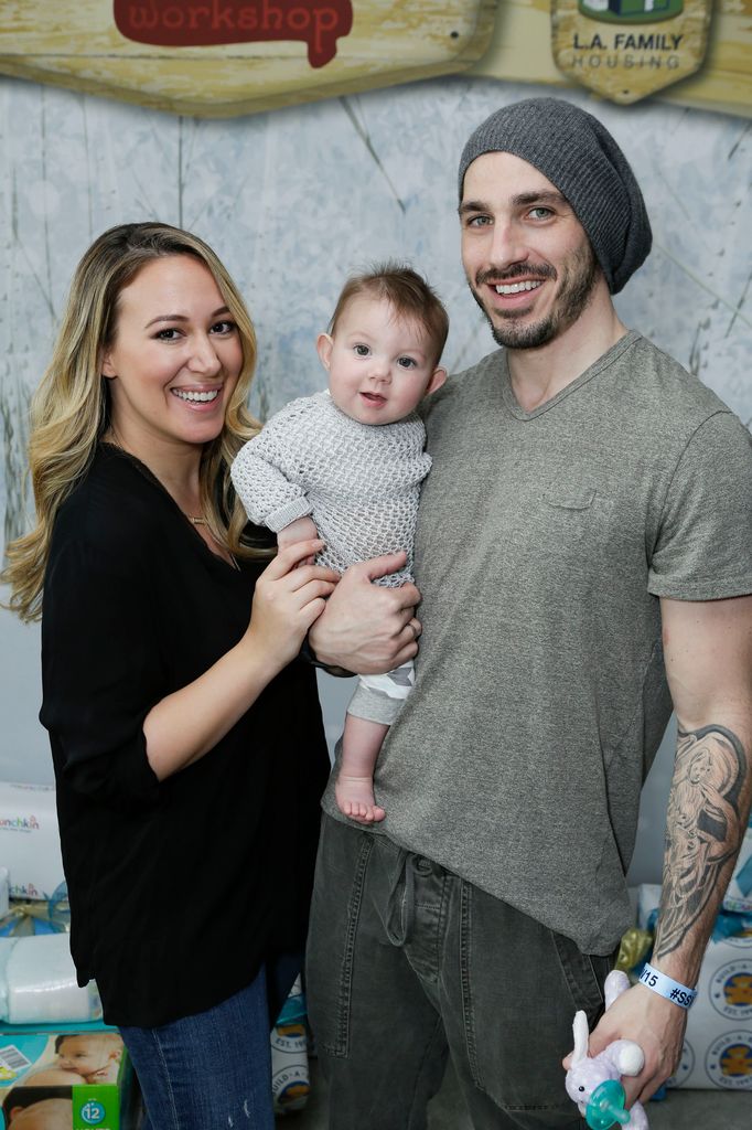 Matthew Rosenberg and wife Haylie Duff hold baby Ryan Rosenberg between them.