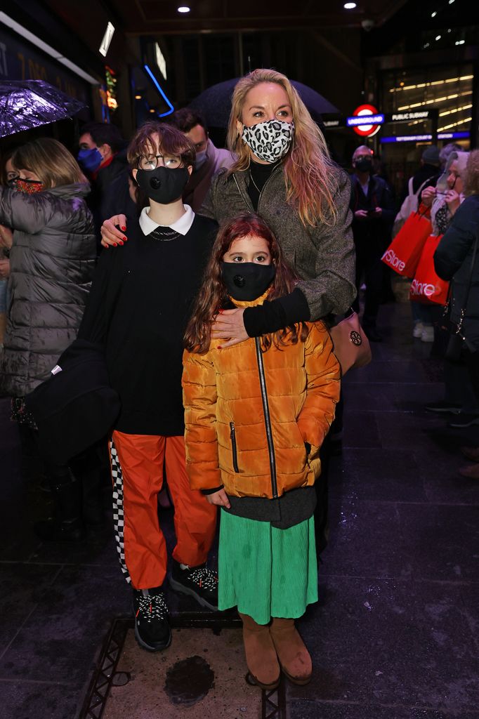Tamzin Outhwaite and her two children wearing face masks