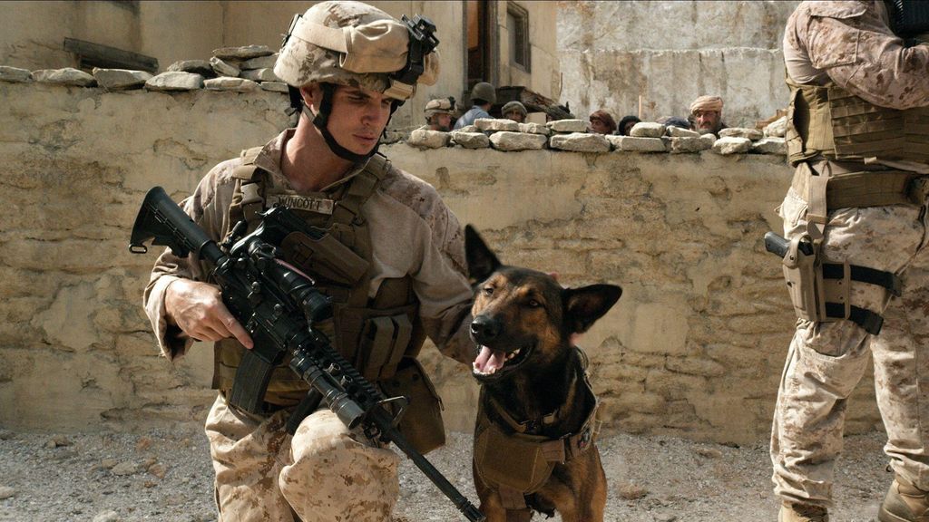 Robbie Amell in a military uniform alongside a dog in a still from Max