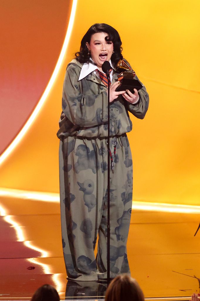 A photo of Lola Young and her Grammy Award