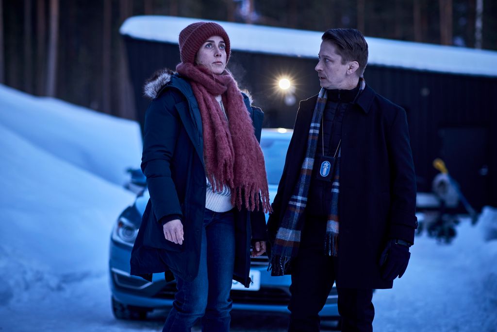 man and woman standing in snow