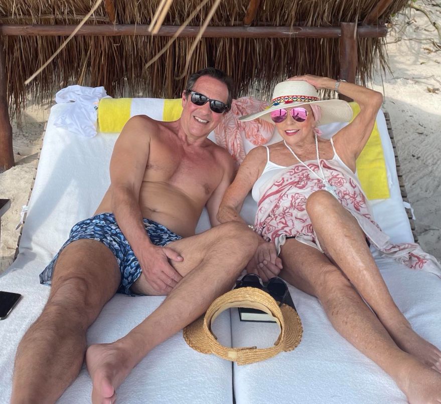 Percy Gibson and Joan Collins relaxing on the beach
