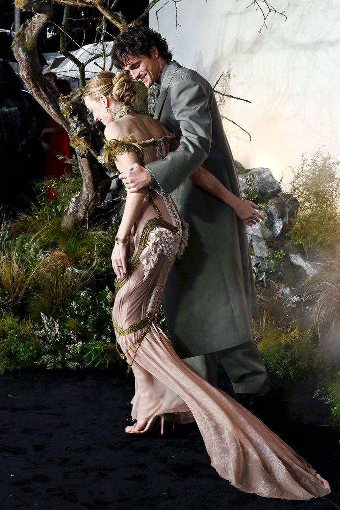 A photo of Jacob Elordi with his arm around Margot Robbie