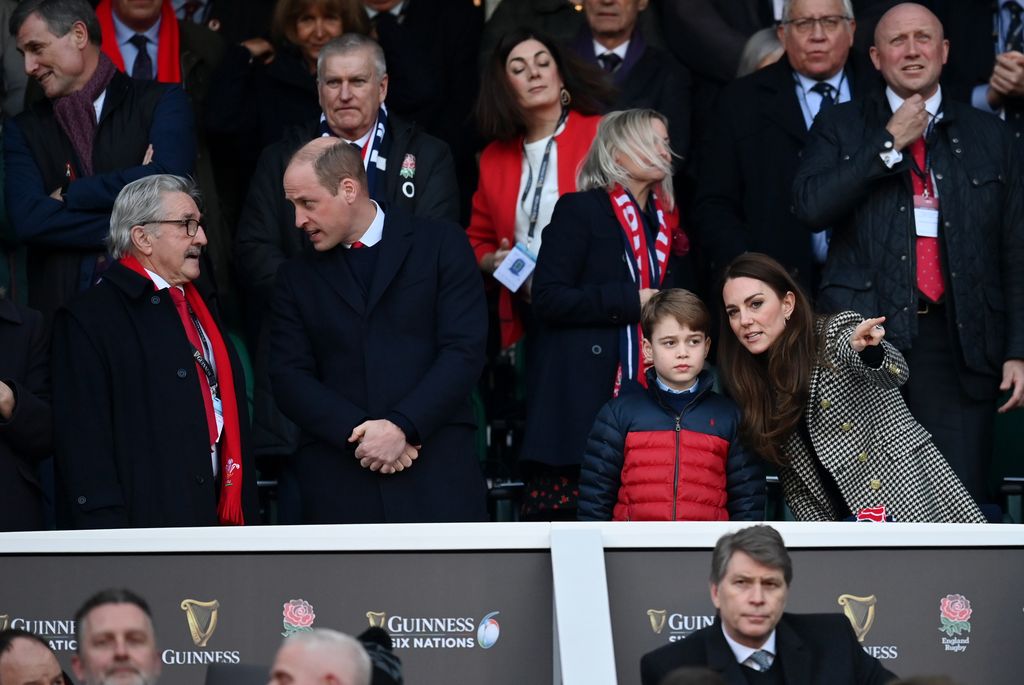 Catherine, speaks to their son Prince George of Cambridge in stands at rugby match