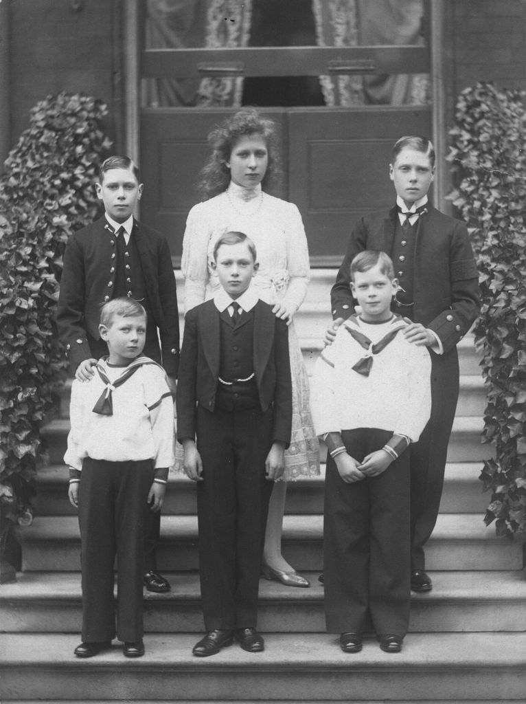 The six children of King George V and Queen Mary pictured on steps in black and white 
