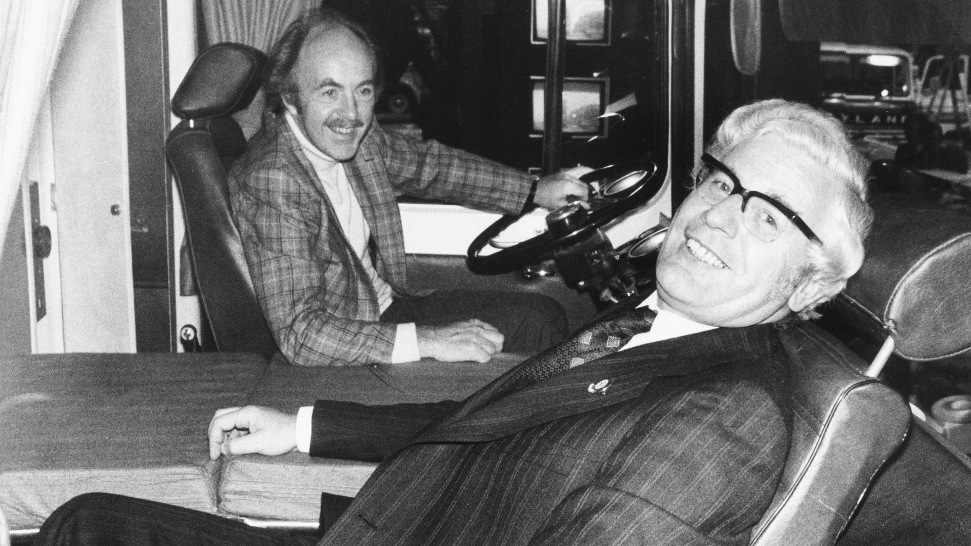 Black-and-white image of Derek Benfield relaxing with Alex Park