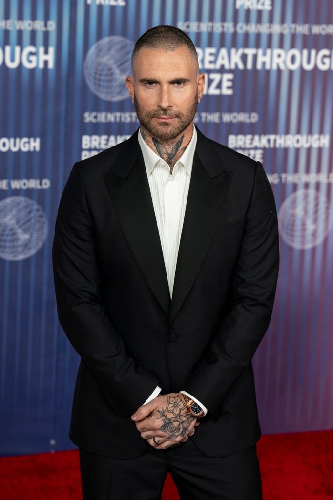 photo of adam levine in black suit