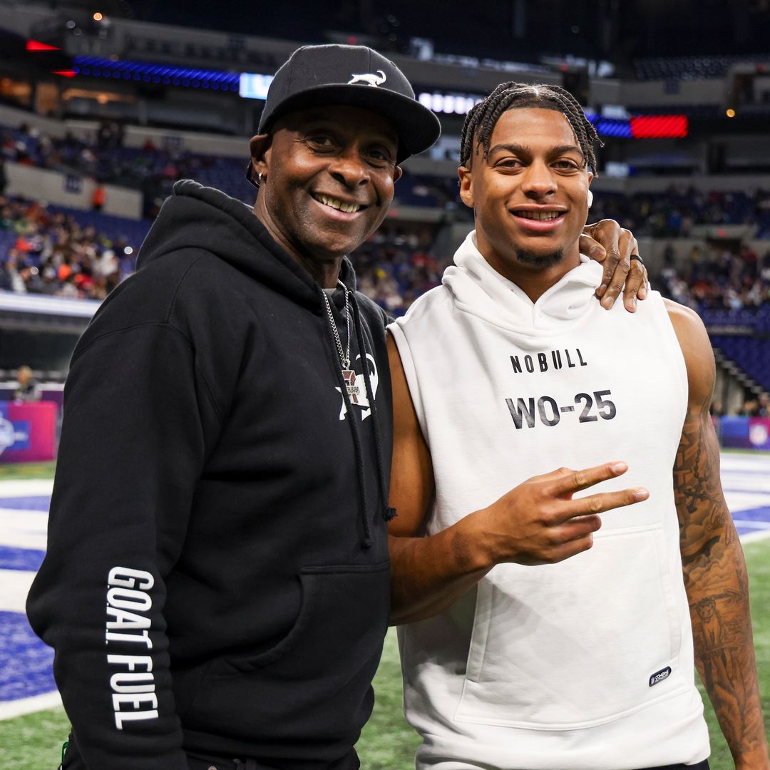 Jerry Rice poses for a picture with his son, Brenden Rice #WO25 of Southern California, during the NFL Scouting Combine at Lucas Oil Stadium on March 2, 2024 in Indianapolis, Indiana.