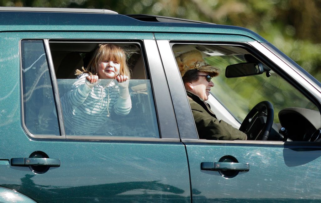Princess Anne driving with granddaughter sticking head out of window