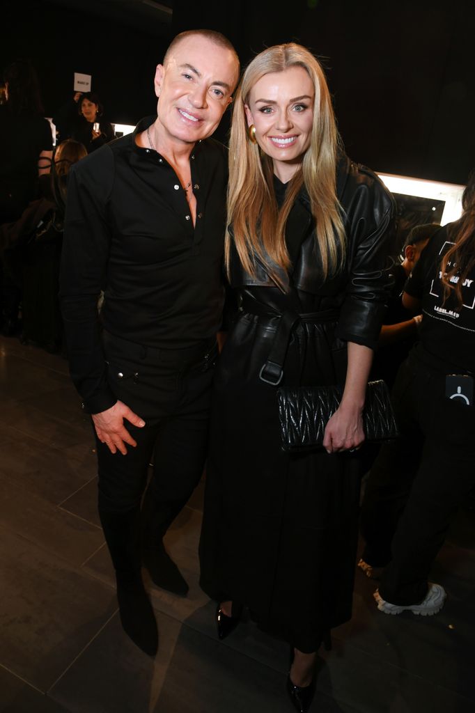 Julien Macdonald posed beside Katherine Jenkins in dark room