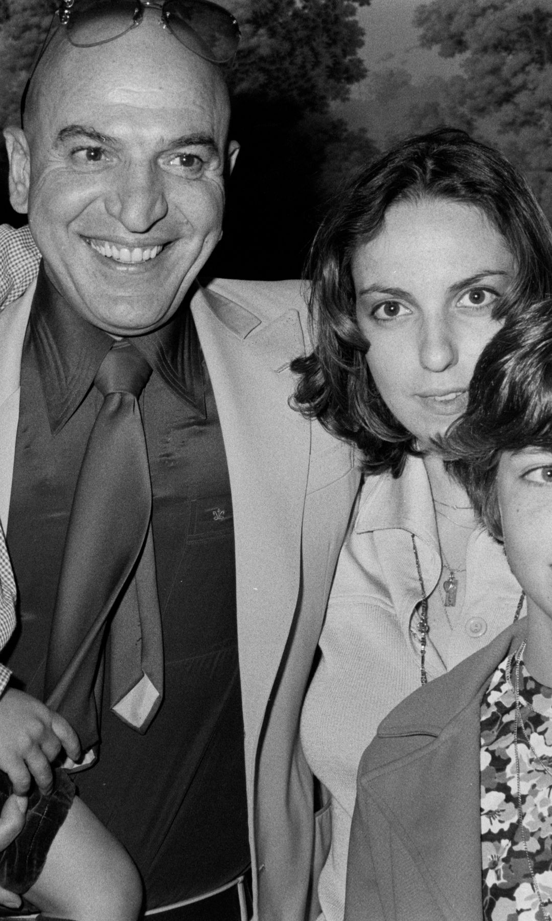 Black-and-white image of Telly Savalas with four of his children