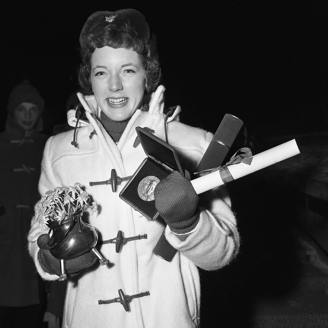 2/5/1956-Cortina, Italy- Figure-skating champion Tenley Albright hugs her awards, after receiving them. The lithe lass from Newton Center, Mass. is the first U.S. woman to achieve first place in the Olympic figure skating event.
