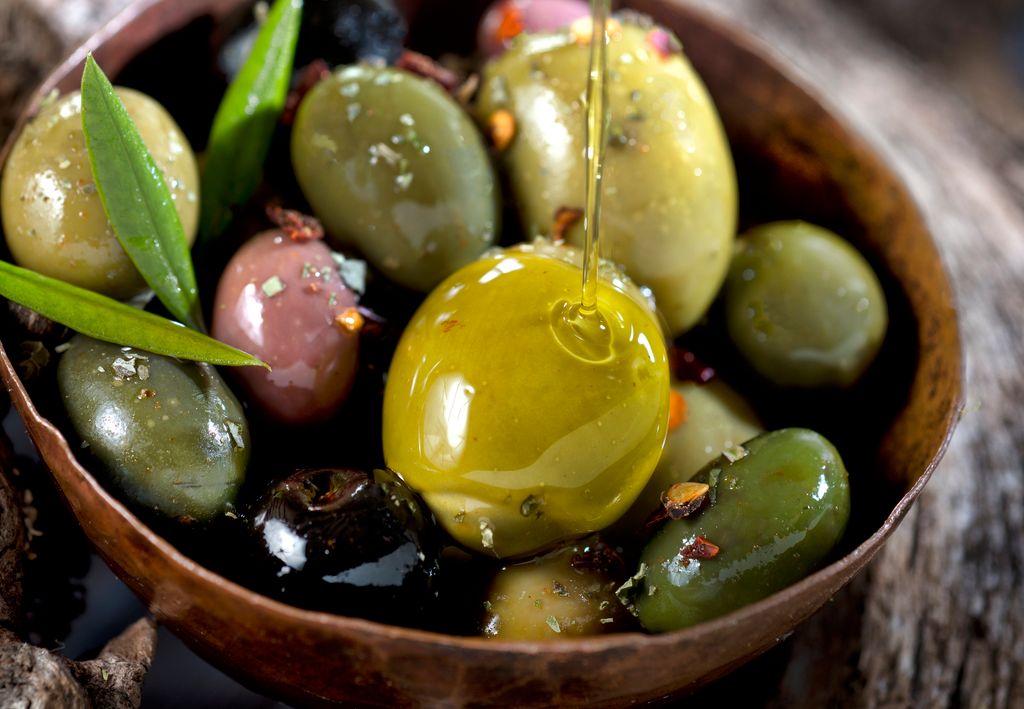 Olive fruit and leaves soaked in olive oil.