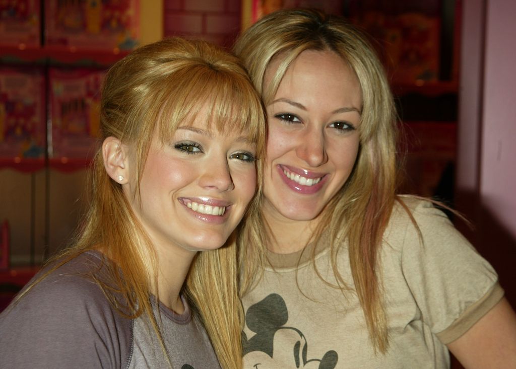 Headshot of Hilary and Haylie Duff in t-shirts smiling at the camera.