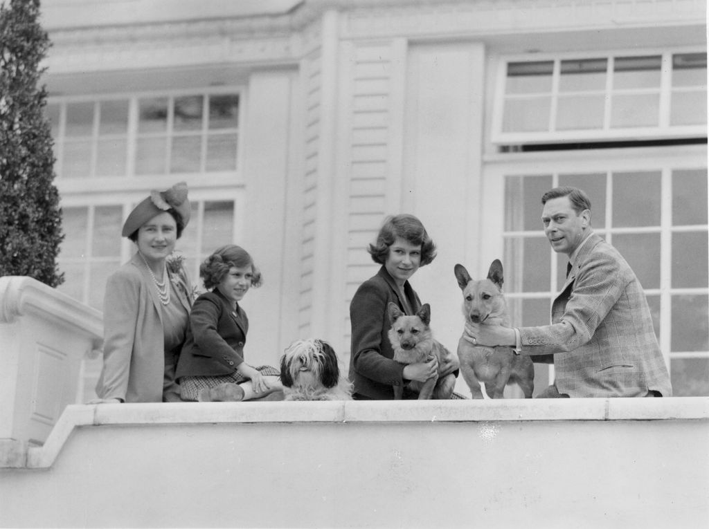 Queen Elizabeth, Princess Margaret, Princess Elizabeth and King George VI at the Royal Lodge with their dogs Ching, Carol and Crackers
