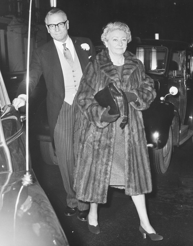Black-and-white photo of Laurence Olivier and Jill Esmond attending a wedding