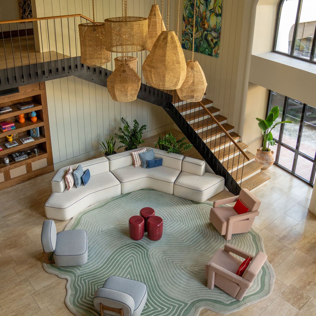 Hotel lobby at Avantgarde Refined Bodrum featuring woven pendant lights, curved seating and a modern open-plan design.