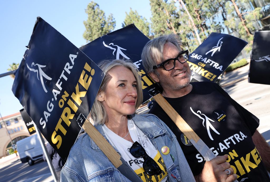 Ever Carradine (L) and Robert Carradine join the picket line outside Warner Bros. Studios on October 31, 2023 in Burbank, California. SAG-AFTRA has been on strike since July 14, 2023 and has not yet reached a deal with AMPTP, the trade association representing the Hollywood Studios