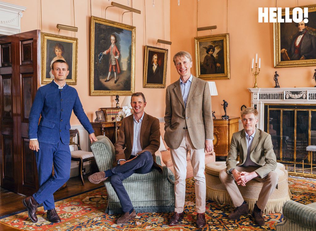 Frederick, Hugh, James and George smiling in their suits, surrounded by paintings at Buscot Park