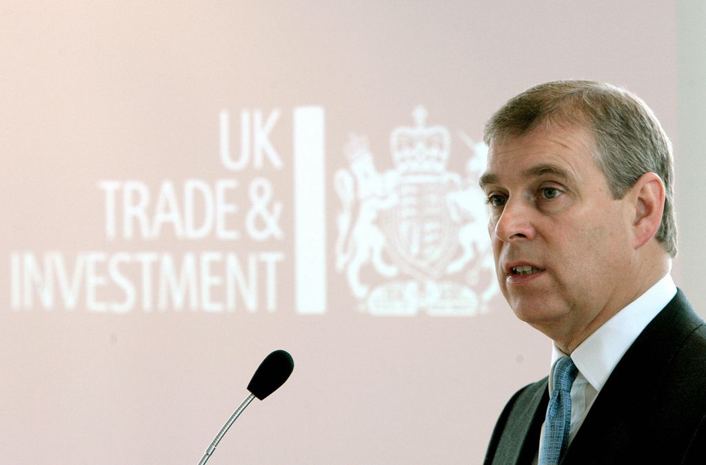 Britain's Prince Andrew speaks into a microphone wearing a suit