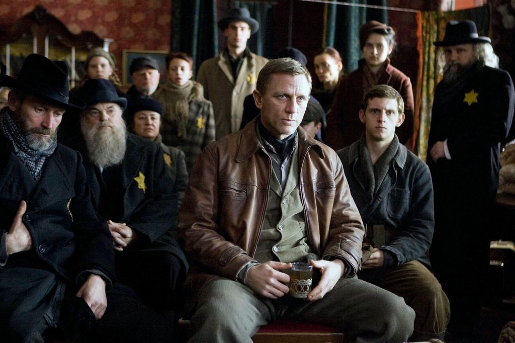 Daniel Craig with Jamie Bell and a group of characters in a still from Defiance