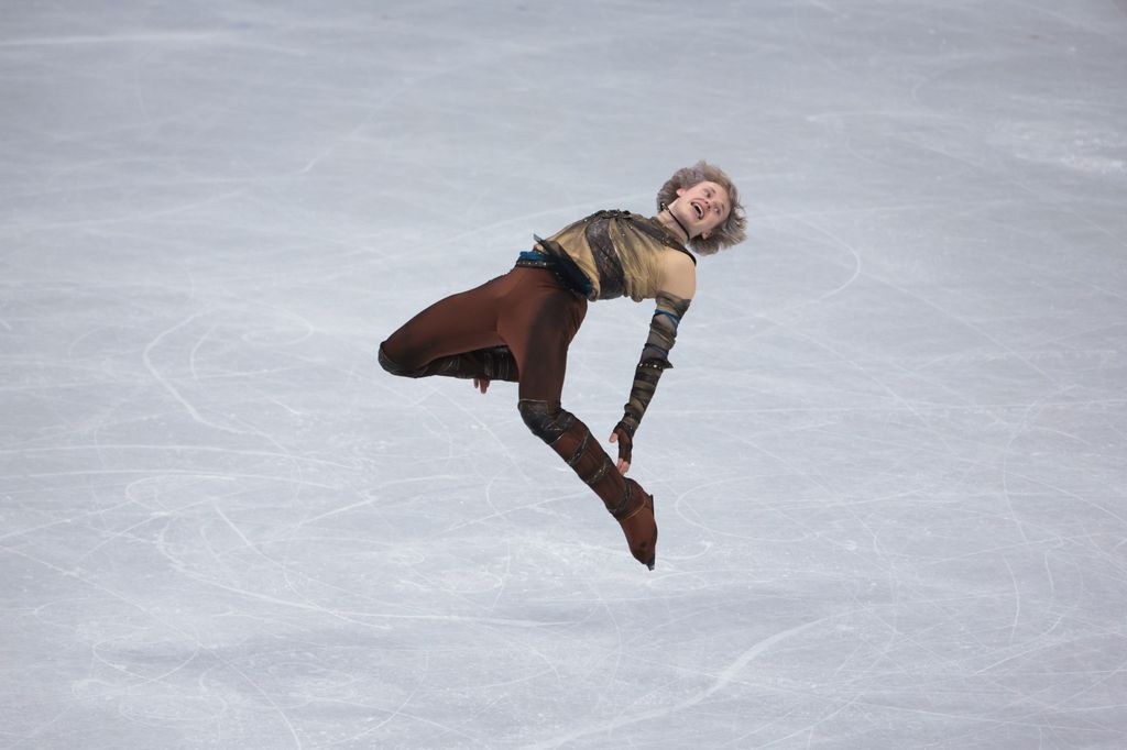 photo of ilia malinin mid air on the ice