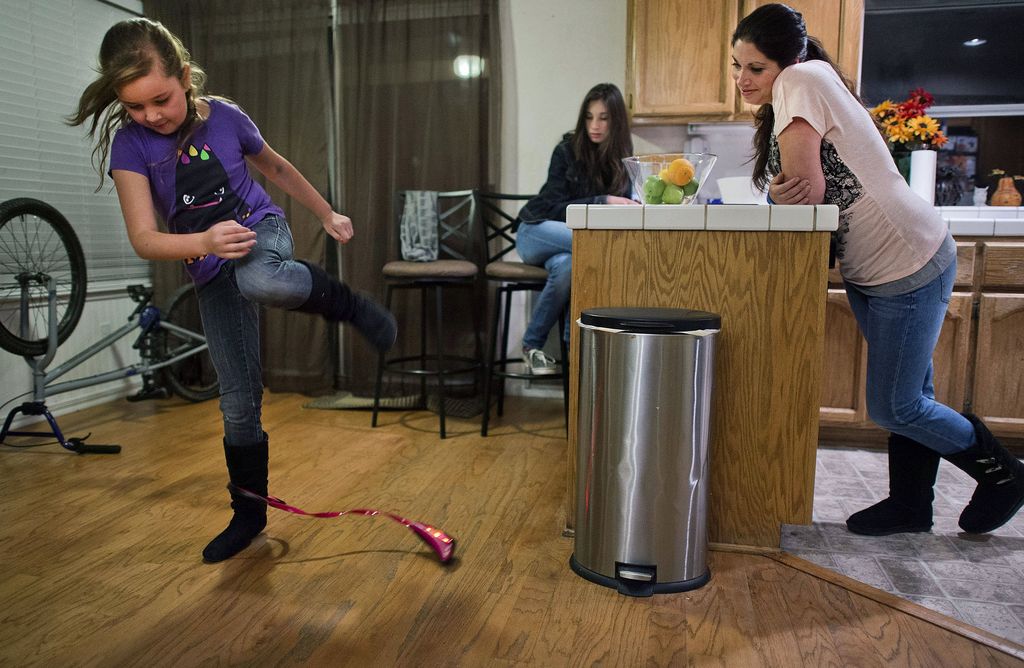 Child hops over a short role attached to his other ankle.