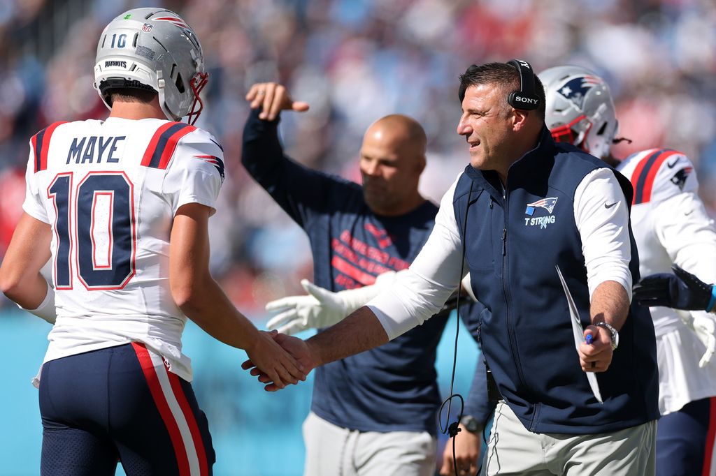 Drake Maye #10 of the New England Patriots celebrates with Head coach Mike Vrabel against the Tennessee Titans in the game at Nissan Stadium on October 19, 2025 in Nashville, Tennessee