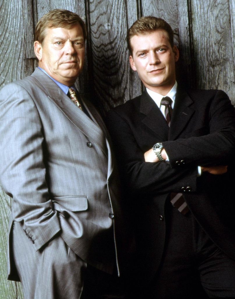 Promotional image of Dalziel and Pascoe featuring Warren Clarke and Colin Buchanan in front of a fence