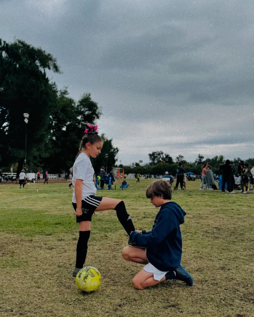 Picture of Daniela Ruah and David Paul Olson's son River (R) tying his sister Sierra's laces