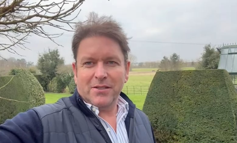 James Martin takes a selfie with his garden, greenhouse and tree house in the background