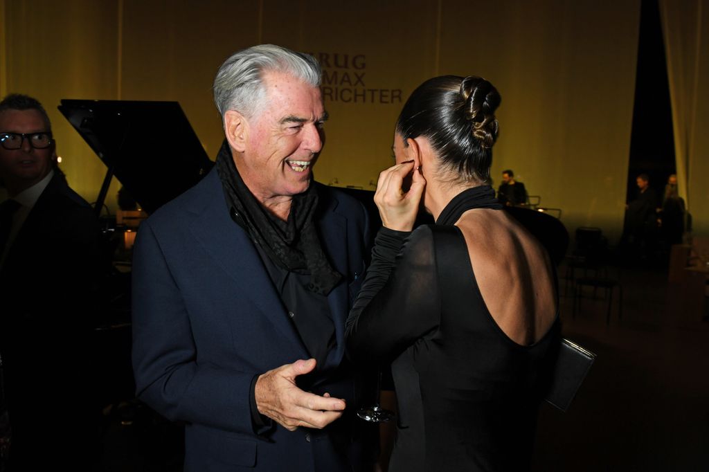 A photo of Pierce Brosnan and Lily James 
