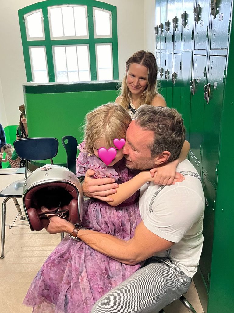 photo of dax shepard hugging daughter while kristen bell looks on