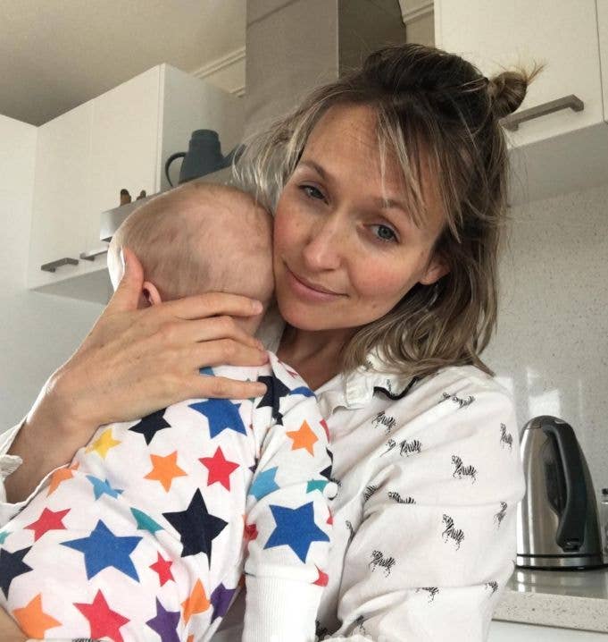 Kate Quilton cradling a baby